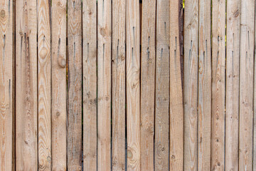 Wooden fence made of unedged boards