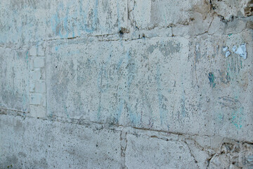 Old shabby wall of large blocks at an angle