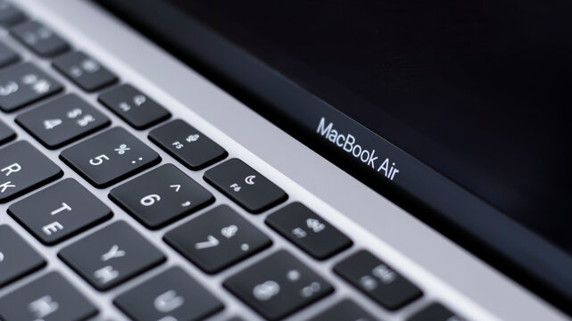 Apple MacBook Air 13 Laptop On Glossy Black Table And Blurred Background. Close-up, Dark Tone. Gomel Belarus - 16.02.2021 