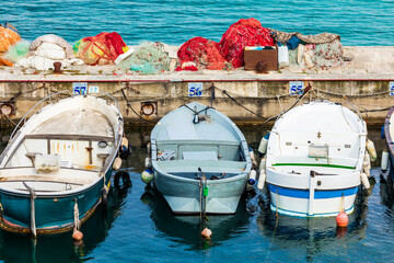 Italy, Apulia, Province of Lecce, Gallipoli. Fishing boats tied up to piers in the Old City.