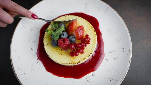 top view of a delicious dessert. Tiramisu or cheesecake garnished with mint and fresh berries.