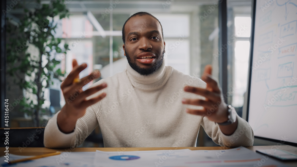 Poster Point of View from Camera with Handsome Young Black Project Manager Making a Video Call in Creative Office Environment. Happy African American Male Specialist Talking to Colleague Over a Live Camera.