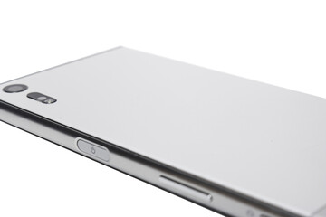 Closeup shot of a backside of a white mobile phone with a camera