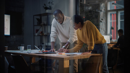 Two Diverse Multiethnic Colleagues Have a Conversation in a Meeting Room Behind Glass Walls in an...