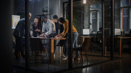 Young Creative Team Meeting with Business Partners in Conference Room Behind Glass Walls in Agency. Colleagues Sit Behind Conference Table and Discuss Business Opportunities, Growth and Development. - obrazy, fototapety, plakaty