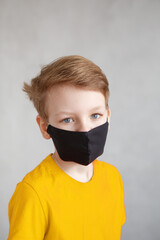 Little boy wearing a mask against corona virus covid-19, 2019-nCov. Kid in a surgical bandage or respirator during corona virus and flu outbreak. Child in a medical mask. quarantine.