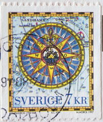 SWEDEN - CIRCA 1997: a postage stamp printed in Sweden with an artistic compass rose. Map symbols in the background..Iceland