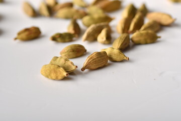 Green cardamom pods on white background