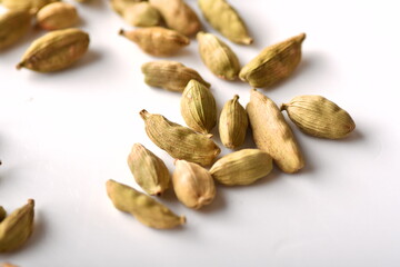 Green cardamom pods on white background