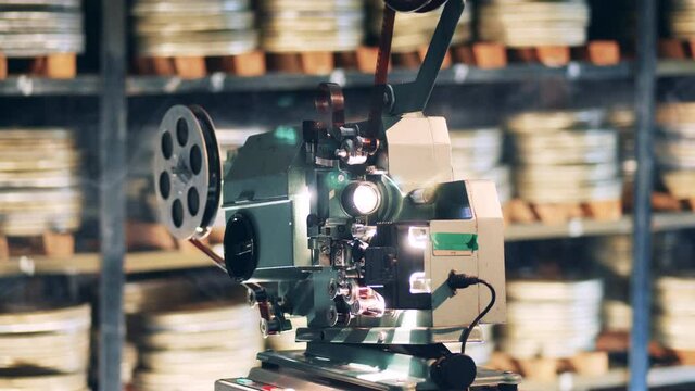 Vintage movie, old cinema concept. Vintage film projector is showing an old movie