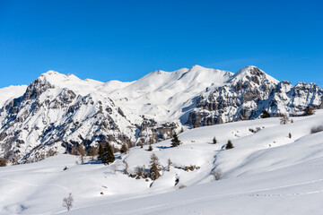 Fototapeta na wymiar Mountain range of the Monte Carega in winter with snow, also called the small Dolomites view from the Altopiano della Lessinia (Lessinia Plateau). Veneto and Trentino Alto Adige, Italy, Europe.