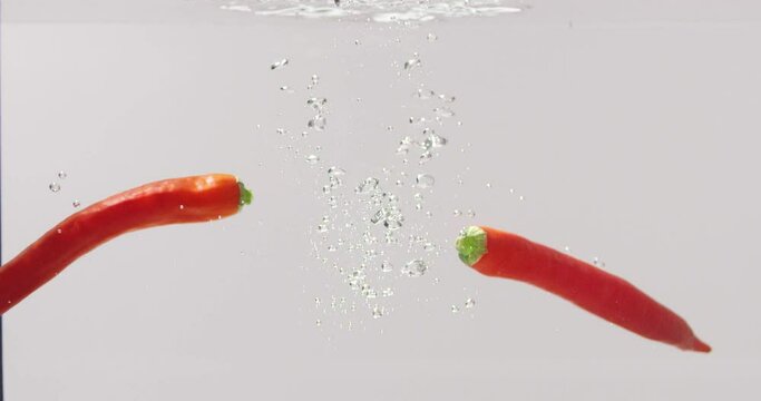 Red peppers are cooked in a saucepan