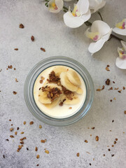granola, yogurt and banana in a glass