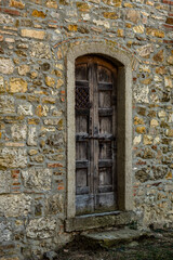 Tuscany, stone wall and old door.