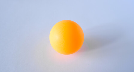 orange ping pong ball on white background close