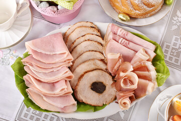 traditional Easter dishes with platter of cured meat on festive table