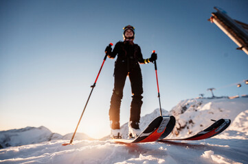 Mountaineer backcountry ski walking in the mountains. Ski touring in high alpine landscape. Adventure winter extreme sport. Sunny day