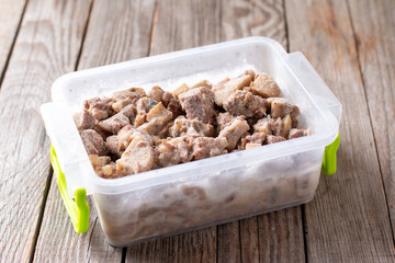 Frozen food in the freezer. Frozen meat, ready meals on a table