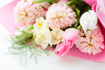 Beautiful bouquet of spring fragrant flowers tulips and hyacinths on a white background. Postcard
