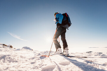 Mountaineer backcountry ski walking in the mountains. Ski touring in high alpine landscape....
