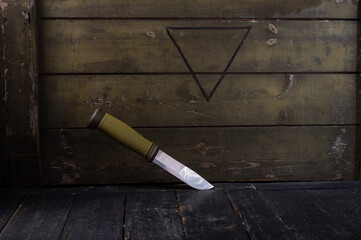 Scandinavian Swedish knife on the background of a green army box.