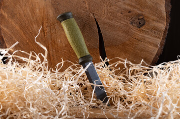Knife lying in the barn in the hay. Fixed blade working knife. Knife embedded in the hay.