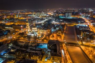 Aerial winter night view to Holy Annunciation Cathedral - Blagovischenskiy sobor, with panorama of embankment of Lopan river at Kharkiv city, Ukraine
