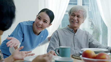 Attractive young senior asian citizen couple happy sit, talk, eat soup for healthy nutrition...