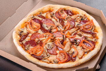 Fresh delicious pizza made in a hearth oven with sausage, pepper and tomatoes