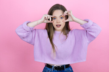 Young pretty woman with long hair standing over isolated pink background Trying to open eyes with fingers, sleepy and tired for morning fatigue