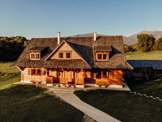 Wooden cottage in nature in sunny day. Recreation center in the mountains. Modern eko hausing in...