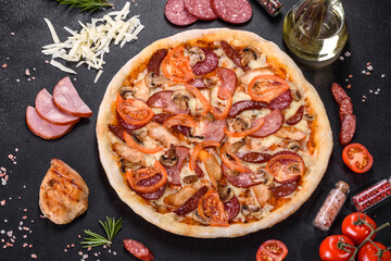 Fresh delicious pizza made in a hearth oven with sausage, pepper and tomatoes