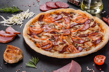 Fresh delicious pizza made in a hearth oven with sausage, pepper and tomatoes