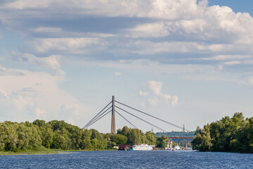 A ship that floats along the river with a view of the bridge