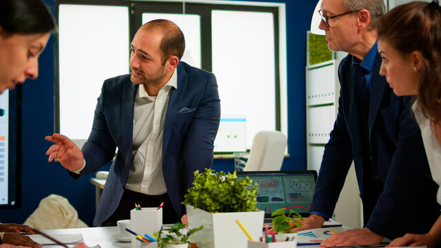 Team of diverse startup company colleague entrepreneur meeting in professional workplace broadroom, brifing and sharing ideas over financial strategy management. Multiracial business people planning.