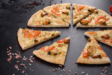 Fresh delicious pizza made in a hearth oven with shrimp mussels and other seafood