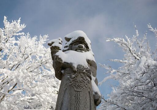 Radegast, Pustevny, Beskids, Czech republic, Czechia -  Statue of god from slavic mythology. Sculpture is covered by white snow in the winter. Shallow focus.