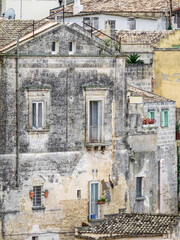 Fototapeta na wymiar Balconies and windows of Sassi homes in the old town of Matera.