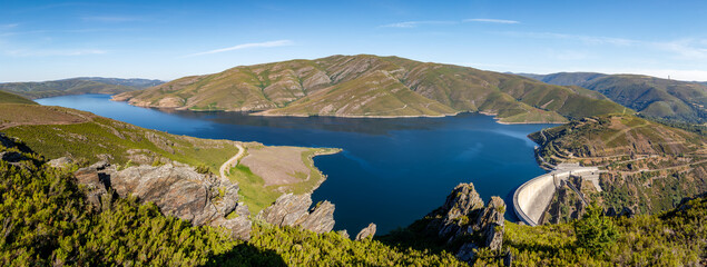 panoramic view of the dam in the mountains with deep blue and clear skies