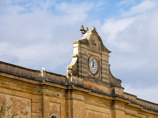 Clock on the facade in old town Matera.