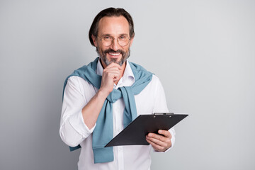 Photo portrait of cheerful ceo of company smiling keeping notepad on interview isolated pastel grey color background