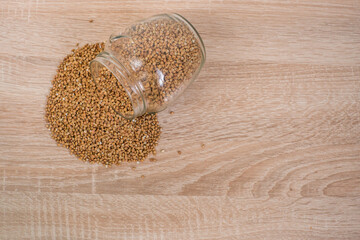 Buckwheat in a glass jar on a wooden table