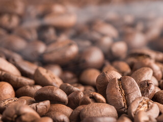 Roasted arabica coffee beans with steam emanating from them after roasting.