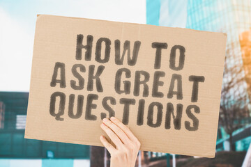 The phrase " How to ask great questions " on a banner in hand with blurred background. Communication. Education. Study. Interest. Student. Classes. Negotiation. Teacher. Teach. Target. Talk. Worried