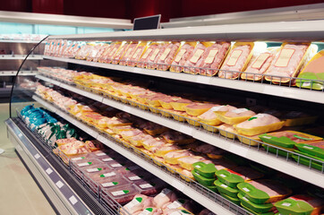 Fresh chicken meat on supermarket shelf, toned