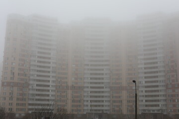 Obraz premium city skyline at night. View of residential skyscraper on a cloudy day. Modern cityscape of Ukrainian capital. Design of contemporary build in big city. Real urban style of residential building.