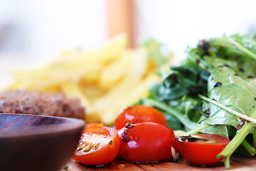 a delicious breakfast, Patty, French Fries, Tomatoes and vegetables.