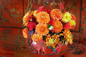 Chrysanthemums and dahlias  in a Chinese wooden vase