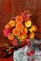 Chrysanthemums and dahlias in a wooden Chinese vase
