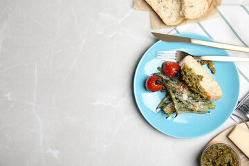 Delicious baked green beans served on grey table, flat lay. Space for text